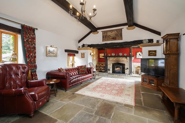 This  stunning room has a vaulted ceiling and a stone fireplace.