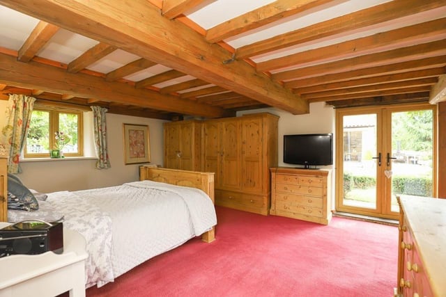 The principal bedroom has an en-suite and doors leading to the grounds of the property.