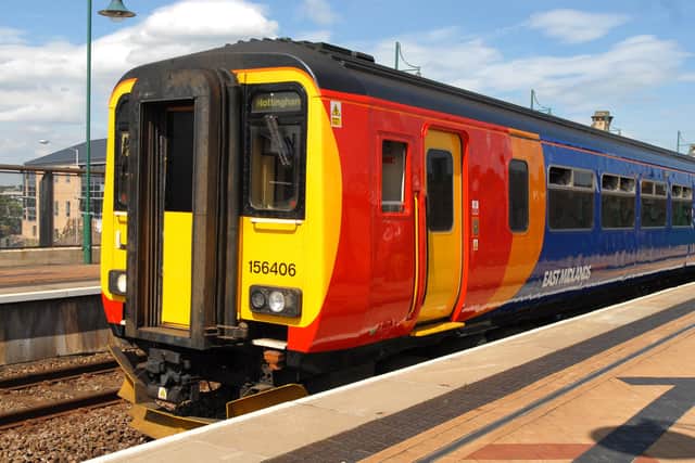 An East Midlands Railway Robin Hood line service, in the company's old colours, stands at Mansfield Railway Station.