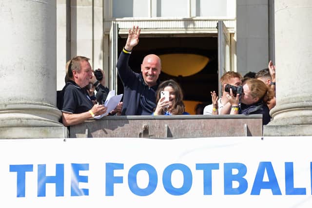 Manager Paul Cook waves to the crowd.