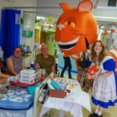 Alice with the Cheshire Cat puppet visits a patient on the Nightingale ward at Chesterfield Royal Hospital.