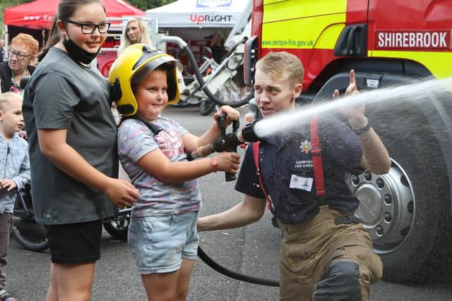 Shirebrook Fire Station open day, Ava and Tia Berry have a go with the fire hose