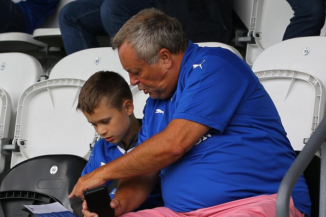 A young fan does his research before kick-off.