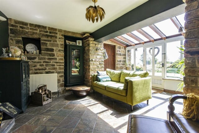 Soak up the sun filtering through the glass in summer or warm yourself in winter beside the stone fireplace.