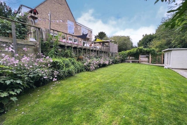 A large expanse of lawn is contained within the quarter-acre plot.