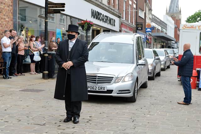 Hundreds of people lined the streets to see Don Hollingworth's funeral cortege pass the market.