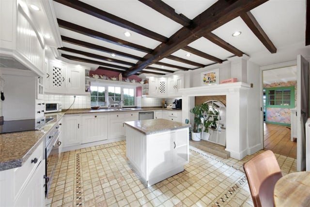 The spacious kitchen features wooden beams and offers plenty of daylight.