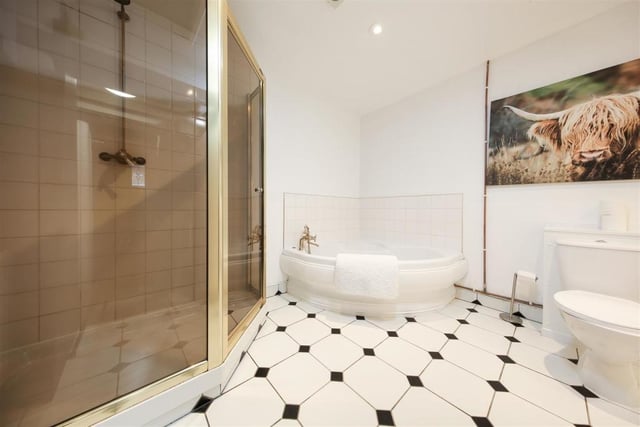 The ground-floor bathroom is fitted with a modern suite including separate bath and shower.