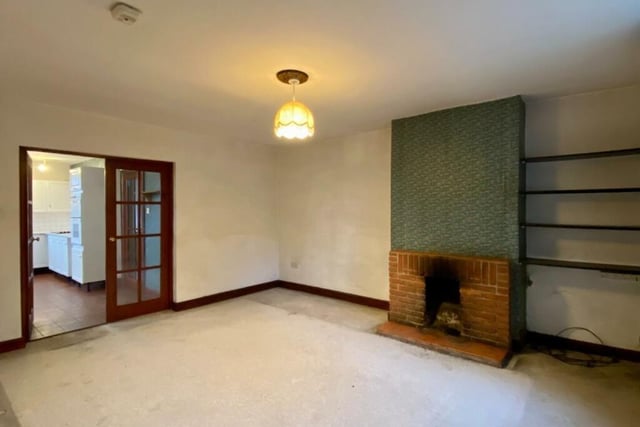 Located through glazed double doors off the kitchen, the dining room is of a good size and has an open fire in a brick fireplace with raised tiled hearth.
