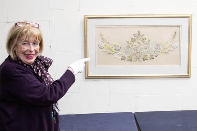 Notty Hornblower, textile consultant at Hansons Auctiioneers, with the embroidered sample made for Queen Elizabeth II’s famous coronation gown (photo: Emma Errington/Hansons)