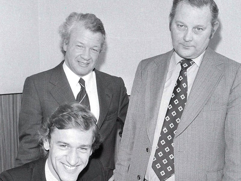 Terry Austin signs watched by Billy Bingham, centre, manager and Joe Eaton, secretary.