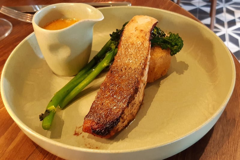 Teriyaki-marinated salmon with a Cajun-spiced rice cake, grilled broccoli, and a sweet & spicy fish sauce, £23.50.