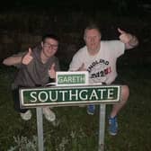 Chris Woolhouse and his stepson Jake Tindale with the amended 'Gareth Southgate' road sign in Eckington.