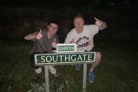 Chris Woolhouse and his stepson Jake Tindale with the amended 'Gareth Southgate' road sign in Eckington.