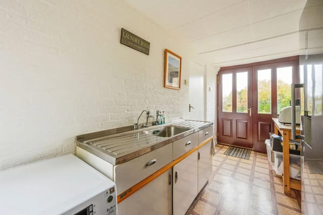 The utility room is located downstairs.  It features a stainless steel sink unit and plumbing for a washer and a wall-mounted mains gas-fired central heating boiler.