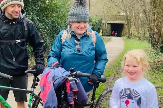 Scarlett Haystead, with her parents Sam and Paul,  has raised £1,036 for charity over two years by walking and biking.