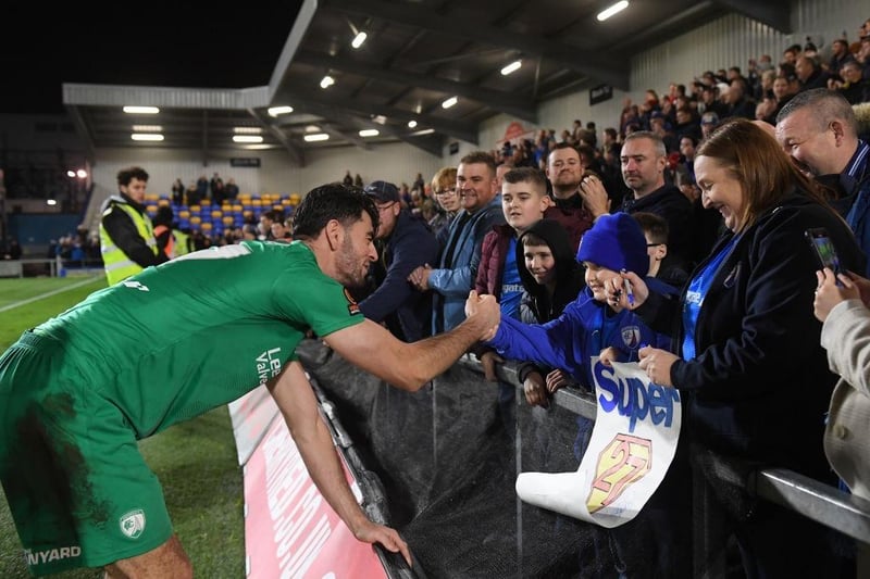 Joe Quigley of Chesterfield celebrates with a fan after the Emirates FA Cup second round match between AFC Wimbledon and Chesterfield at The Cherry Red Records Stadium on November 26, 2022.