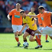 BLACKPOOL, ENGLAND - APRIL 10: Jack Wilshere of Arsenal competes with Ian Evatt of Blackpool during the Barclays Premier League match between Blackpool and Arsenal at Bloomfield Road on April 10, 2011 in Blackpool, England.  (Photo by Chris Brunskill/Getty Images)