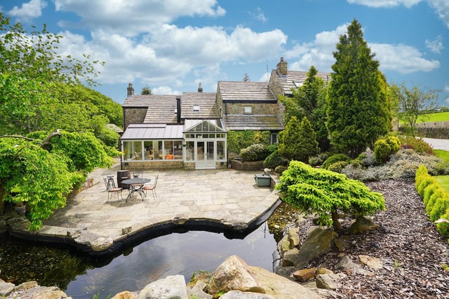 The grounds are beautifully landscaped to three sides with stone-paved patios.