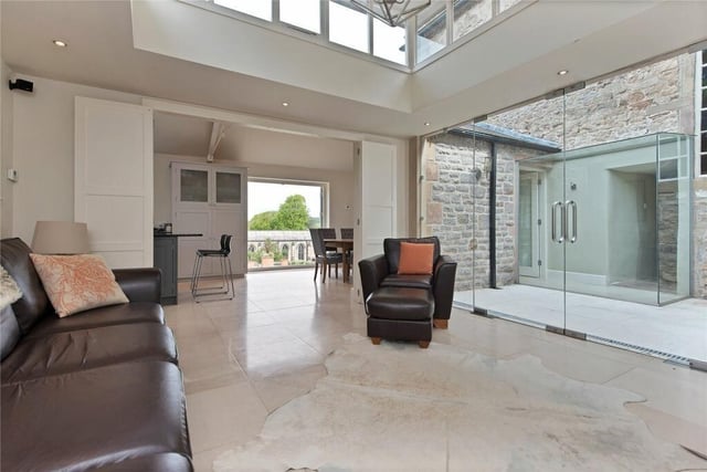 This stunning orangery is accessed from the open-plan kitchen and from an internal courtyard.