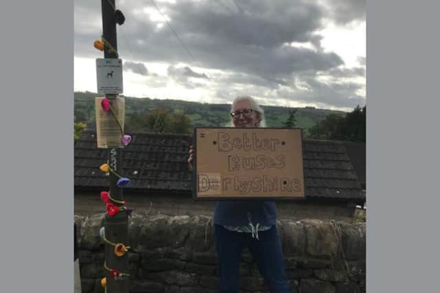 Local bus campaigner Chrissy Grocott at a ‘dressed’ bus stop (credit Derbyshire Climate Coalition)
