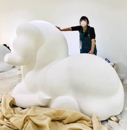 Artist Lynne Hollingsworth with the giant ram.