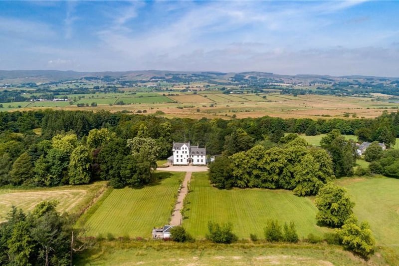 Aerial view showing house and grounds and surrounding countryside.