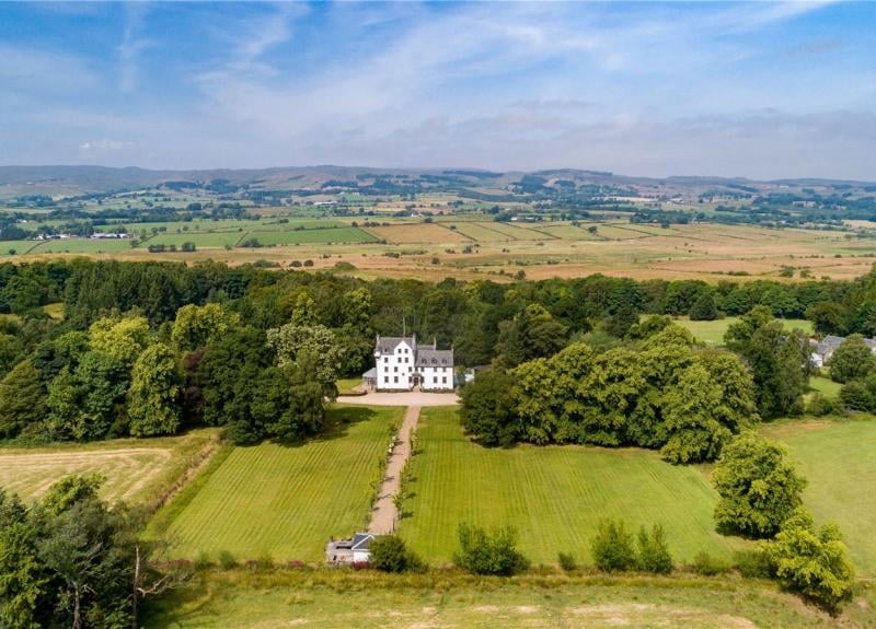 Aerial view showing house and grounds and surrounding countryside.