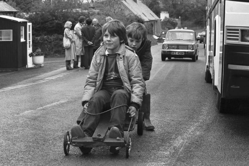 Liberal-SDP politician David Steel's son Rory Steel and his friend Bruce Armstrong on their guider, next to the Battlebus in the run up to the General Election in May 1983.