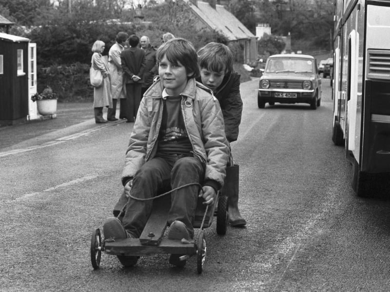 Liberal-SDP politician David Steel's son Rory Steel and his friend Bruce Armstrong on their guider, next to the Battlebus in the run up to the General Election in May 1983.