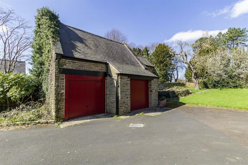 The listed former coach house and stables now serves as a double garage with attached two-storey store.