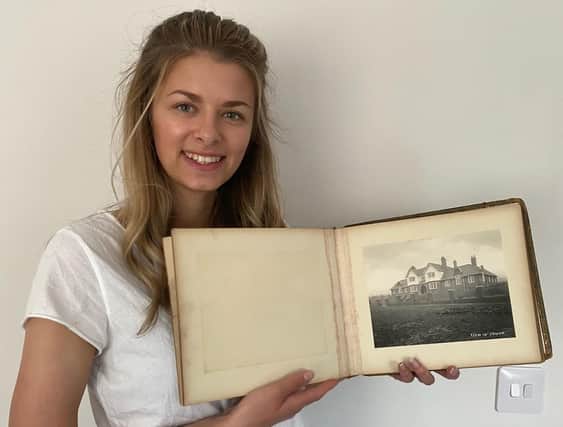 Alice Bennett with the album of photos taken when Bainbridge Hall in Bolsover was built to house the orphaned children of miners.