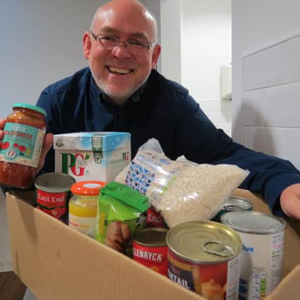 Senior auditor at The Nottingham, David Cobbin, pictured with some of the items from a food collection the building society held previously for the Trussell Trust.