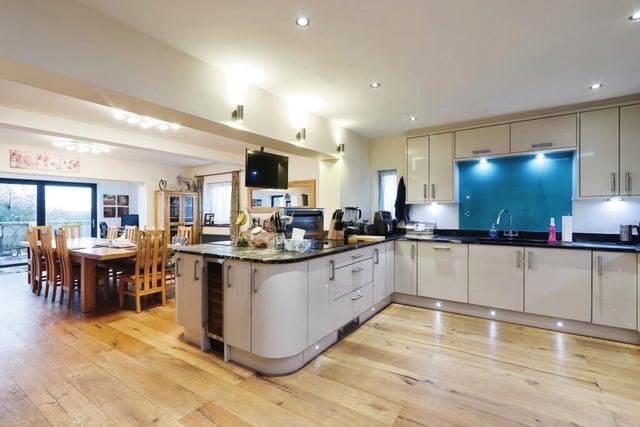 The highlight of the ground floor is this modern, open-plan kitchen that embraces a dining area, which is ideal for family gatherings and entertaining guests, and also a snug. Note the engineered oak flooring.