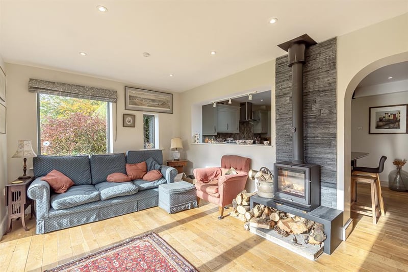 Bright and spacious, this stylish living space is bathed in light from the patio doors which open out to the garden, while the central log burner is perfect for cosy evenings.