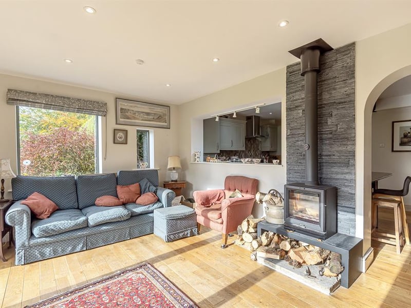 Bright and spacious, this stylish living space is bathed in light from the patio doors which open out to the garden, while the central log burner is perfect for cosy evenings.