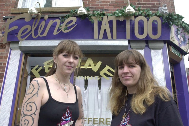 Maria Murray and Jayne Limer pictured on the other side of the shop showing what the sign shold look like,  at Feline Tattoo, Hunters Bar, after the sign was stolen in 2001