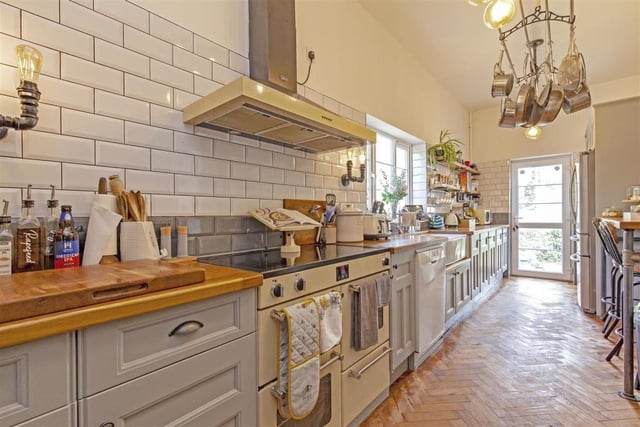 Bespoke base and wall units, wooden worktops and an inset Belfast sink/drainer are features of the breakfast kitchen. There is an electric Aga with chimney extractor over.