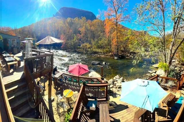 Hickory Nut Gorge Brewery's bar in Chimney Rock overlooks a river with crystal-clear water.