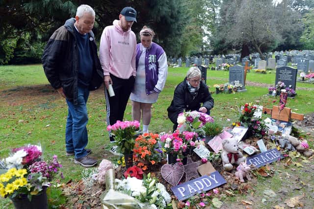 Richard and Alison at Gracie's graveside with her brother Tom, 22, and sister Abi, 15