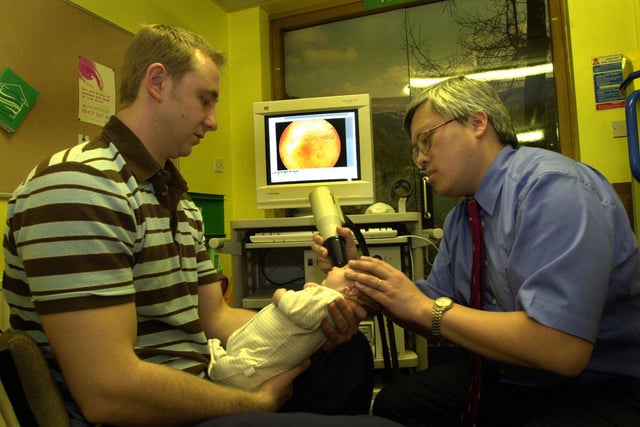 Consultant opthalmic surgeon Johnathan Chan scans four-week-old Jake Westmoreland's eye with a 'retcam' in 2002.