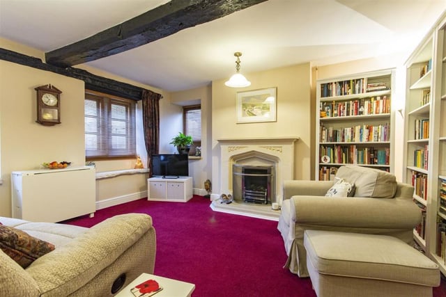 Original oak beams and a stone fireplace with gas fire are focal points of the lounge.