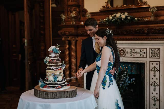 The new Mr and Mrs Crawford cut the wedding cake. Photo by McAra Photography.