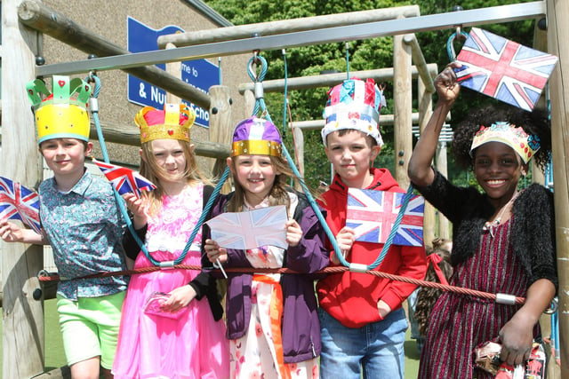 Hady Primary School pupils flying their handmade union jack flags and donning their crowns