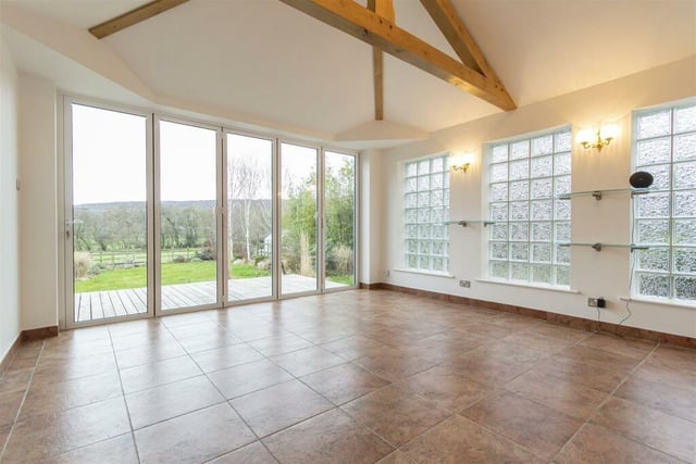 This lovely room offers a great view of the scenery beyond the garden and has underfloor heating, a vaulted ceiling and a glass block wall.