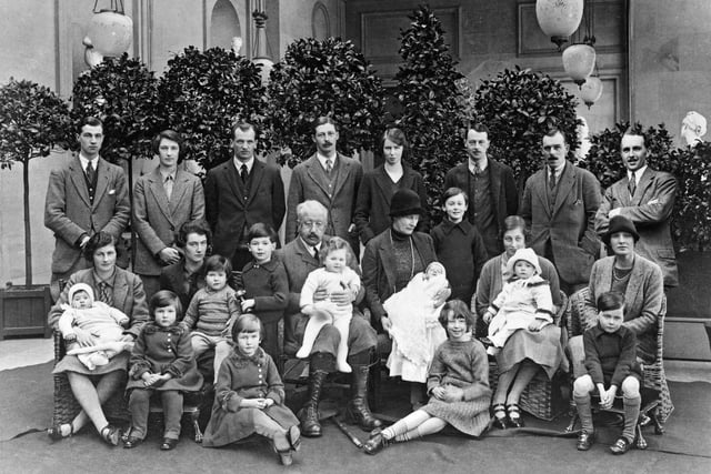 Victor Cavendish, 9th Duke of Devonshire, with his children and grandchildren at Chatsworth, Derbyshire, Christmas 1925. Andrew Cavendish, the 11th Duke, sitting at his mother's feet on the far right.  (Photo by NEMPR Picture the Past/Heritage Images/Getty Images)