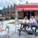 The Bridge Inn's tenants Sophie and Dan Orton relax in their pub's outdoor space which now boasts a new bar, patio and picket fencing.