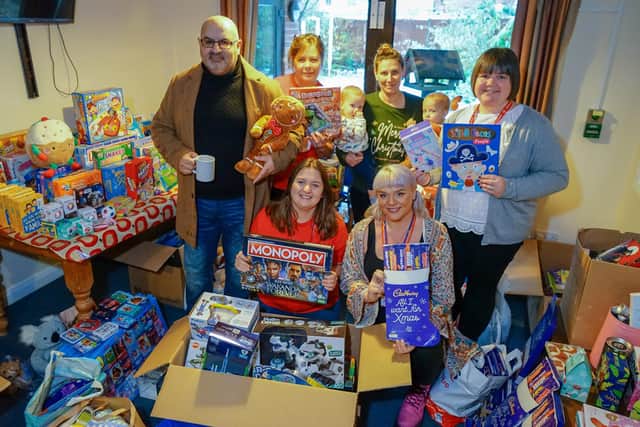Sam Bannister, Claire Schofield, Laura Cockroft, Michelle Pashley, Debbie Moore, Ginny Chandler with youngsters Nico and Wilf at the hand over for the Christmas toy appeal