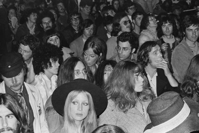 English musician, singer and songwriter, John Lennon (1940 - 1980) (lower centre) and Japanese artist, singer, and peace activist, Yoko Ono, in the crowd during the Isle of Wight Music Festival, August 1969. (Photo by William Lovelace/Daily Express/Hulton Archive/Getty Images)