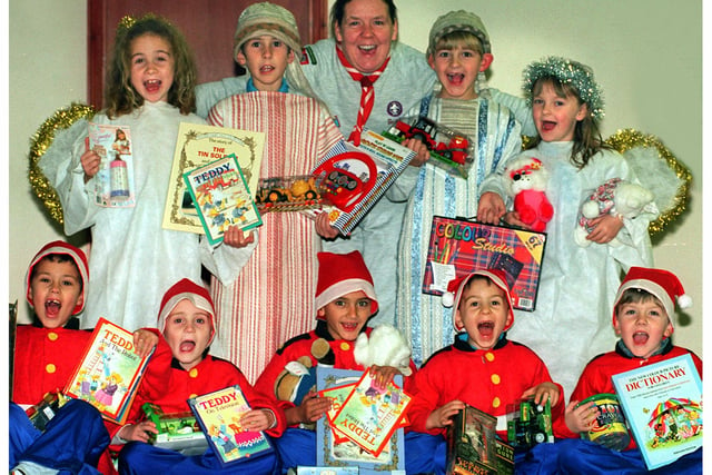 The 270th Intake Beaver Group held a Nativity Play in 1999 and with the money raised  bought toys for The Star toy appeal, pictured is Beaver leader Sandra Bickerstaff with the children and the toys